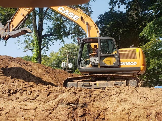 CASE CX160D excavator working a spoil pile