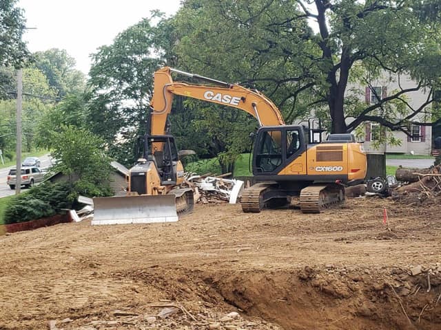 DeLuca Brothers excavator and dozer pair clearing a site